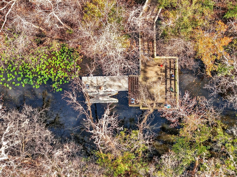 Aerial view of a dock extending over the water in Whisper Creek
