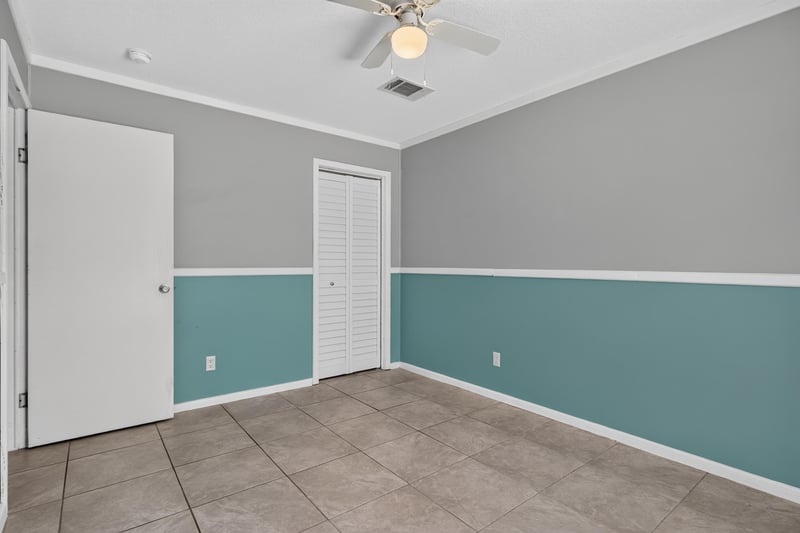 Bedroom with closet door and tile floor at 2549 Snapdragon Ave, Middleburg, FL 32068
