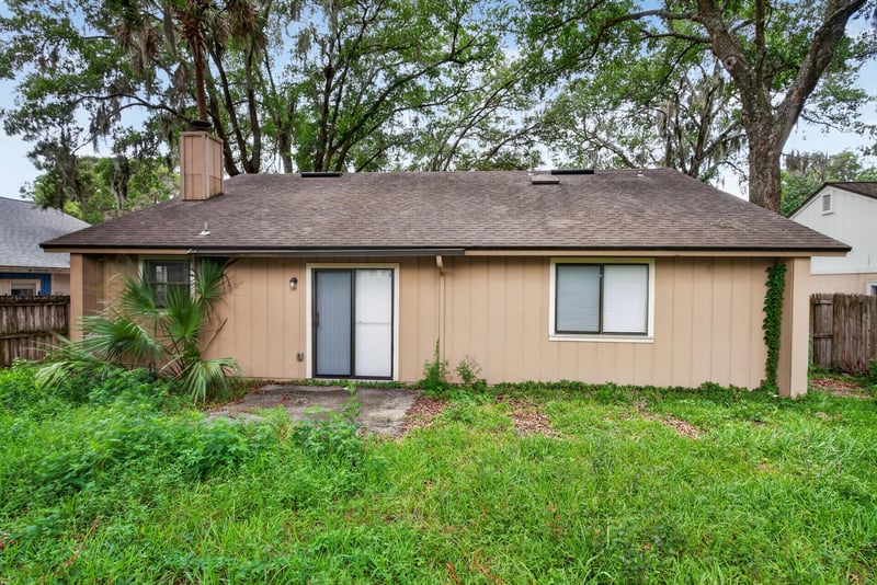 Front exterior with board siding and composite roof at 1445 Classic Oak Rd W, Jacksonville, FL
