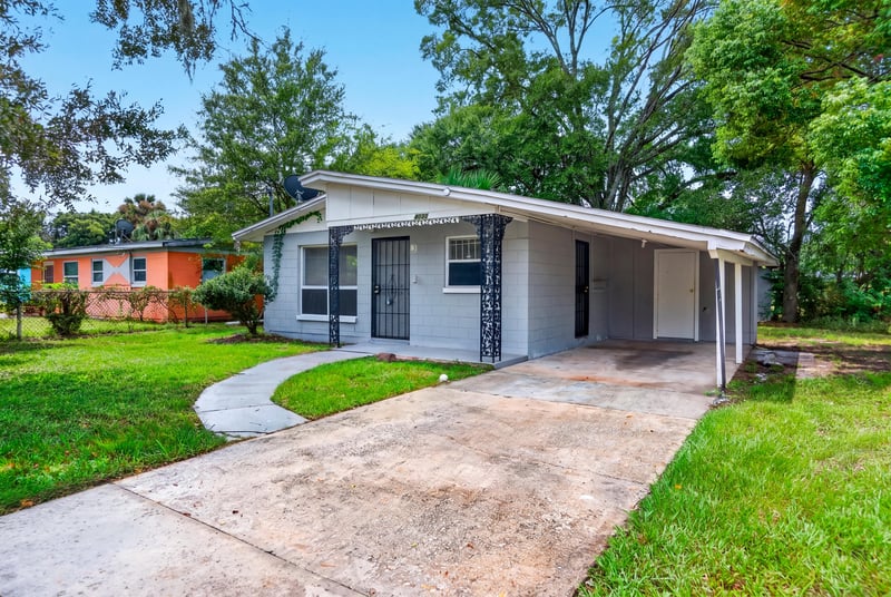 Front exterior with walkway and mature trees at 4030 Leonard Cir W, Jacksonville, FL 32209
