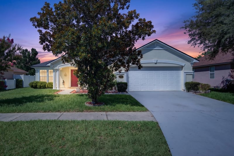 Day-to-dusk front exterior with lit windows at 2282 Justin Lake Dr, Jacksonville, FL