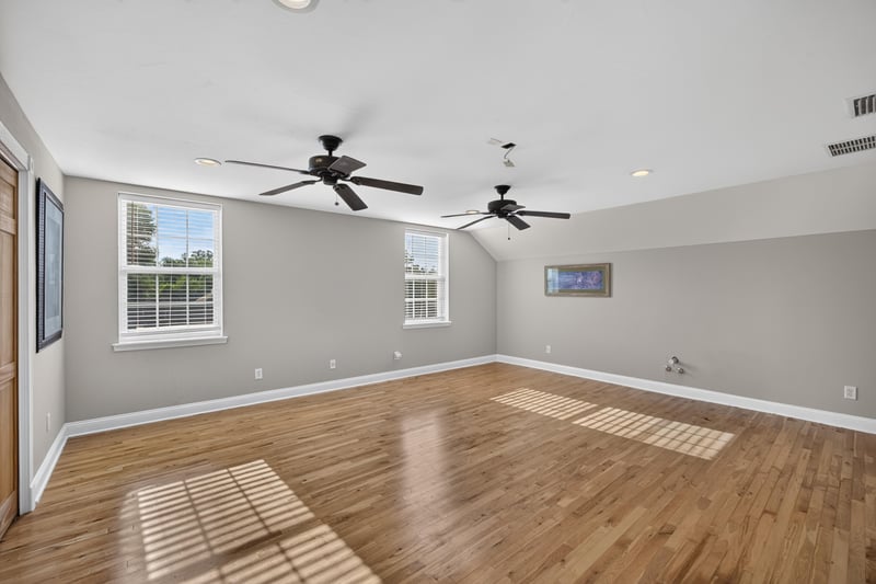 Bonus room with hardwood floors and two ceiling fans at 1735 Hagans Ridge Ct