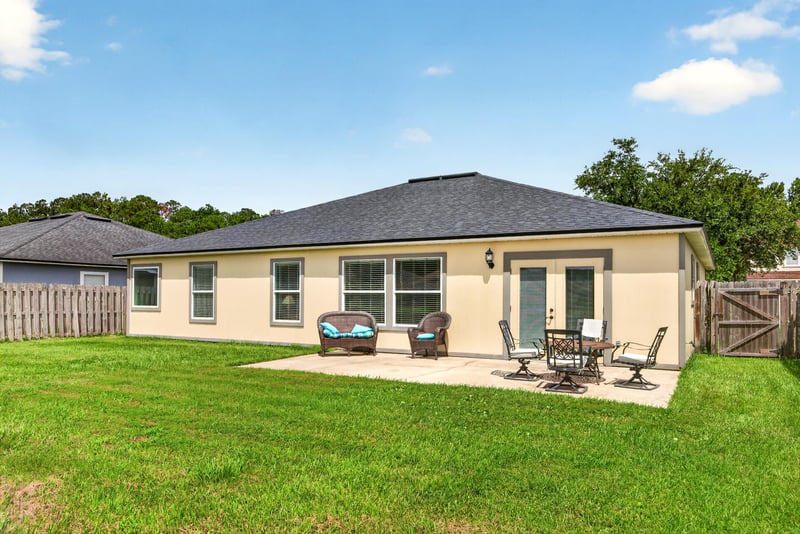 Back exterior with patio table and chairs at 2065 Creekmont Dr