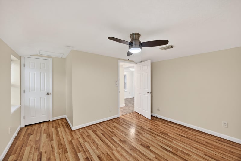 Empty room with wood floors leading to hallway at 1619 Hammond Blvd, Jacksonville, FL
