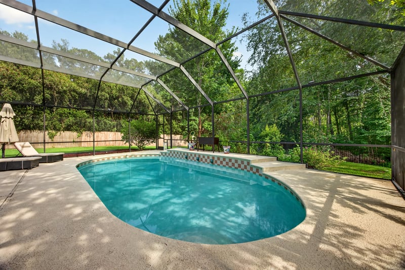 Pool with handrail and screened lanai at 2125 Blue Heron Cove Dr, Orange Park, FL 32003