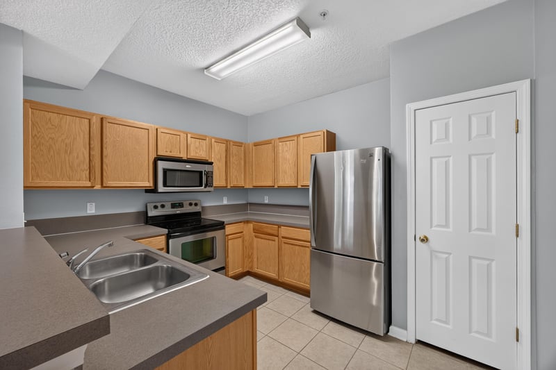 Kitchen sink and oak cabinets at 575 Oakleaf Plantation Pkwy, Orange Park, FL 32065