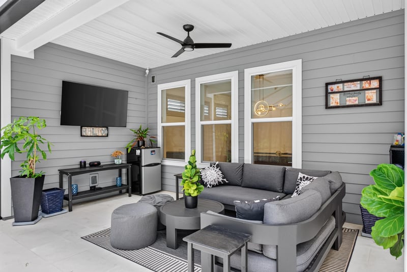 Covered lanai living area with TV and pool view at 785 Back Creek Dr, St. Augustine, FL 32092
