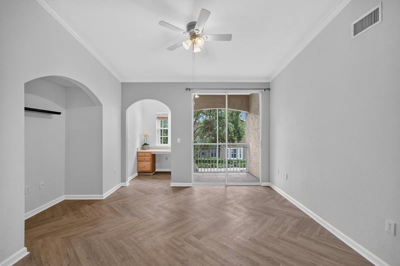 Open living and dining area with hardwood floors and arched doorway at 10075 Gate Pkwy unit 1905, Jacksonville, FL 32246