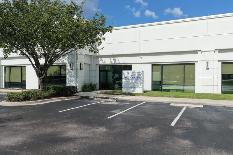 Building front with trees and parking lot at 10550 Deerwood Park Blvd, Jacksonville, FL 32256