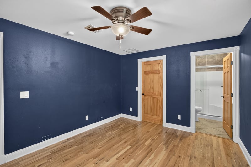 Bedroom with navy walls and hardwood floors at 1735 Hagans Ridge Ct