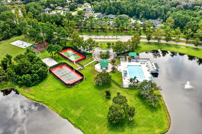 Aerial overview of community pool, courts, and pond in Jacksonville, FL