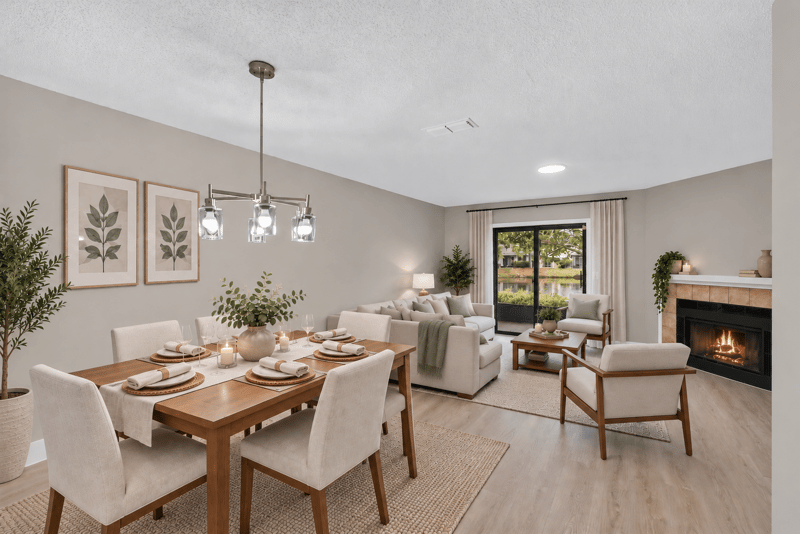 Virtually staged living and dining area with fireplace at 3801 Crown Point Rd, Jacksonville, FL 32257