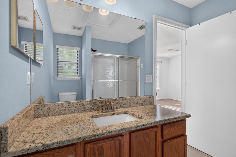 Bathroom with blue walls and granite vanity at 353 Redwood Ln