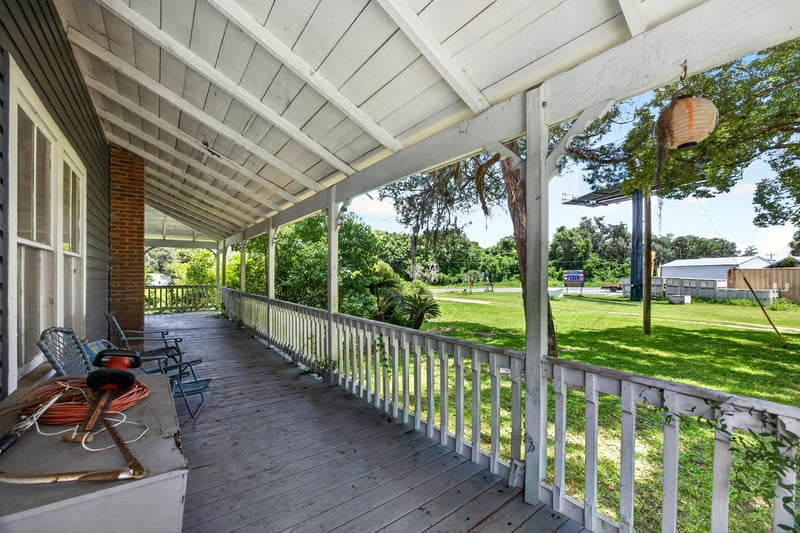 Covered porch walkway with ceiling fans at 1173 US-17, Satsuma, FL 32189