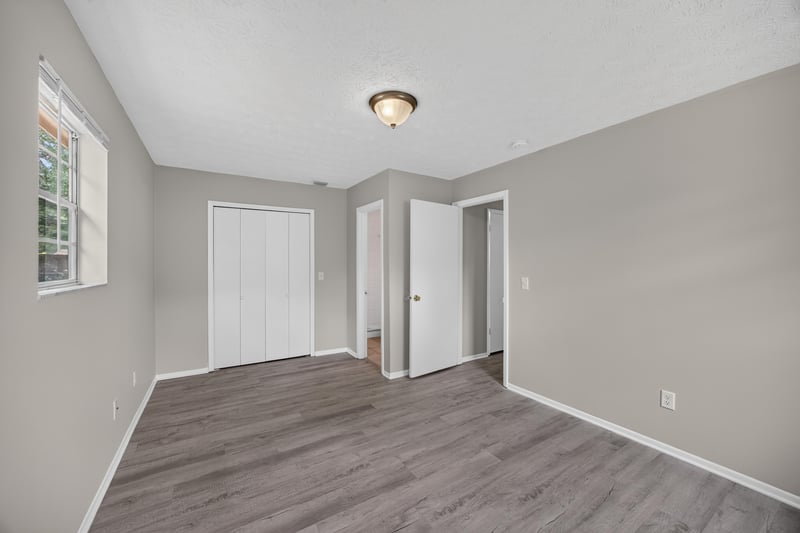 Empty room with double closets and wood-look flooring at 1083 Stokes St, Jacksonville, FL