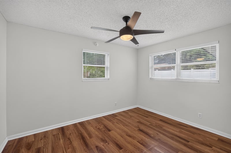 Bedroom with windows, wood floor and ceiling fan at 4039 Habana Ave, Jacksonville, FL