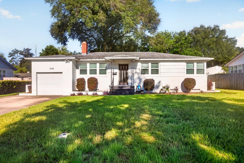 Front exterior wide view with mature trees at 6338 Mercer Cir W, Jacksonville, FL