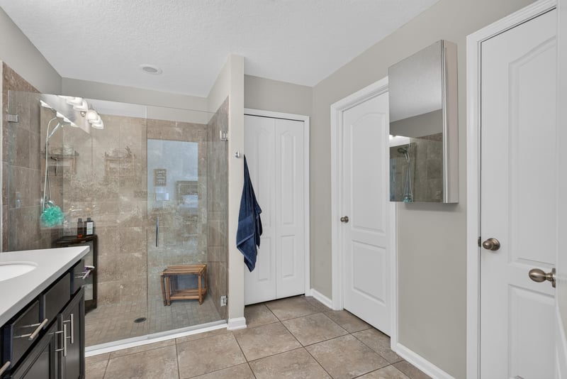 Primary bathroom walk-in shower with tile surround at 589 Seville Pkwy, St. Augustine, FL