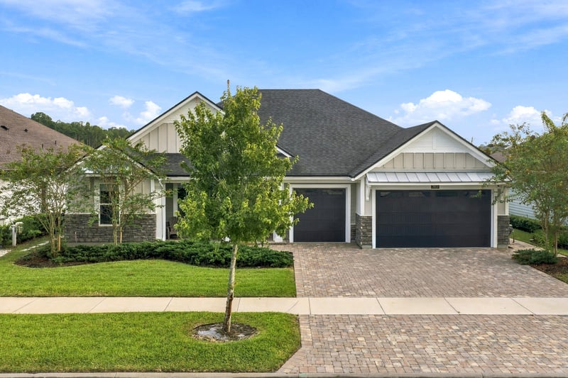 Front exterior with gable roof and paver driveway at 3921 Spyglass Hill Ln