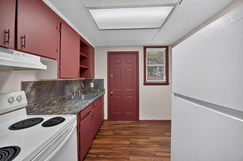 Kitchen with red cabinets and white range at 2132 Allandale Cir W, Jacksonville, FL