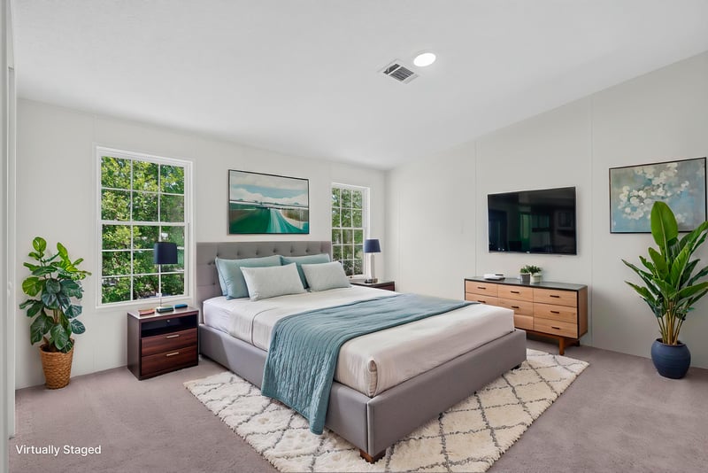 Bedroom staged with bed and wall-mounted TV at 7603 Coach Park Dr, Jacksonville, FL 32244