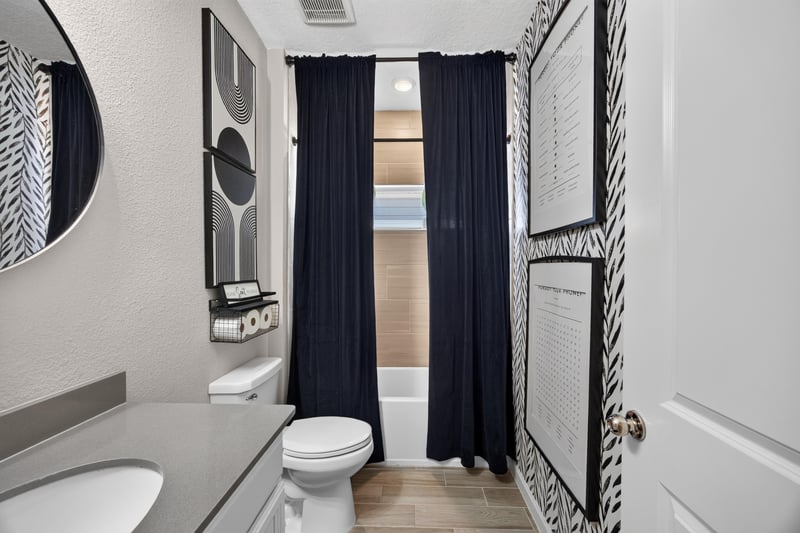 Secondary bathroom with tub and shower curtain at 9942 Lovage Ln, Jacksonville, FL 32219