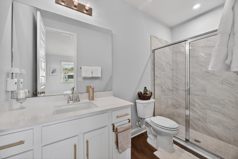 Bathroom with dual sink vanity and glass shower at 85491 Fall River Pkwy, Fernandina Beach, FL 32034