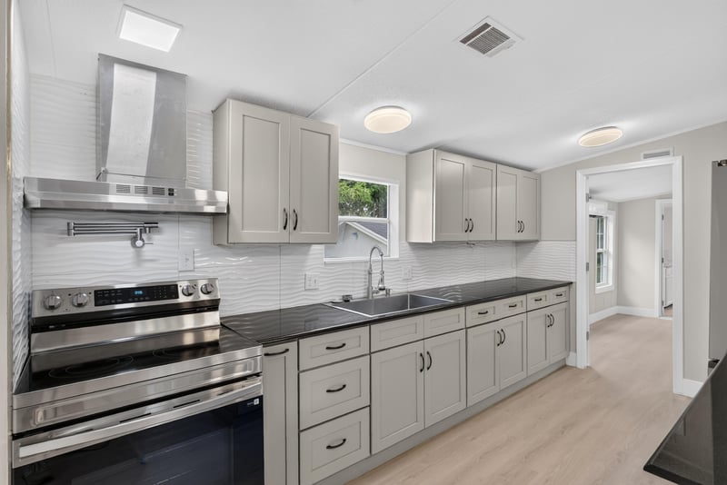Kitchen with vent hood and tile backsplash at 4565 Appleton Ave, Jacksonville, FL