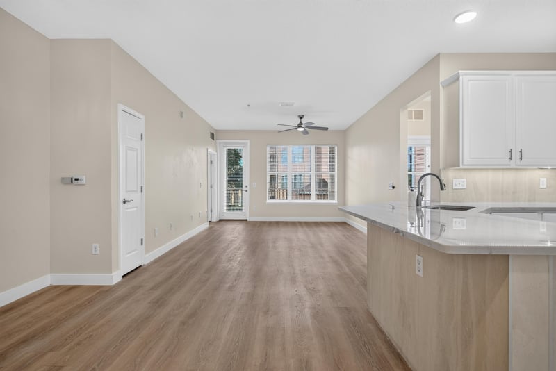 Open kitchen and living area with white cabinets at 11251 Campfield Dr unit 1202, Jacksonville, FL 32256