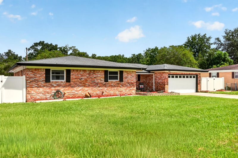Front exterior view of brick ranch home and lawn at 6059 Karen St, Jacksonville, FL 32244