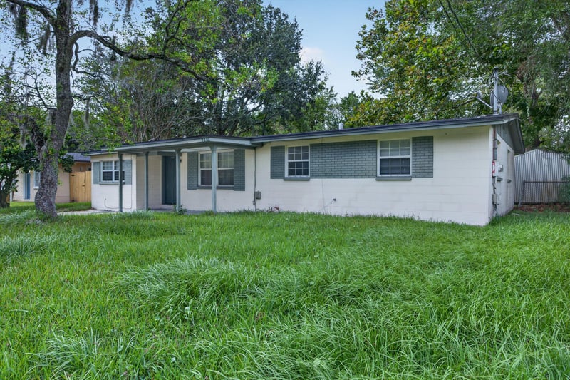 Front elevation with green shutters at 5812 Tampico Rd, Jacksonville, FL 32244