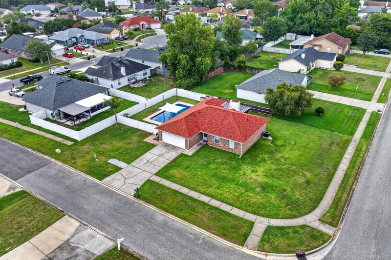 Aerial view of the home along the street at 2164 Orangewood St, Middleburg, FL 32068