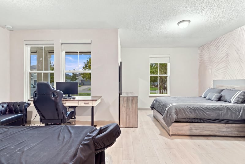 Bedroom set up as office with desk and massage chair at 3921 Spyglass Hill Ln