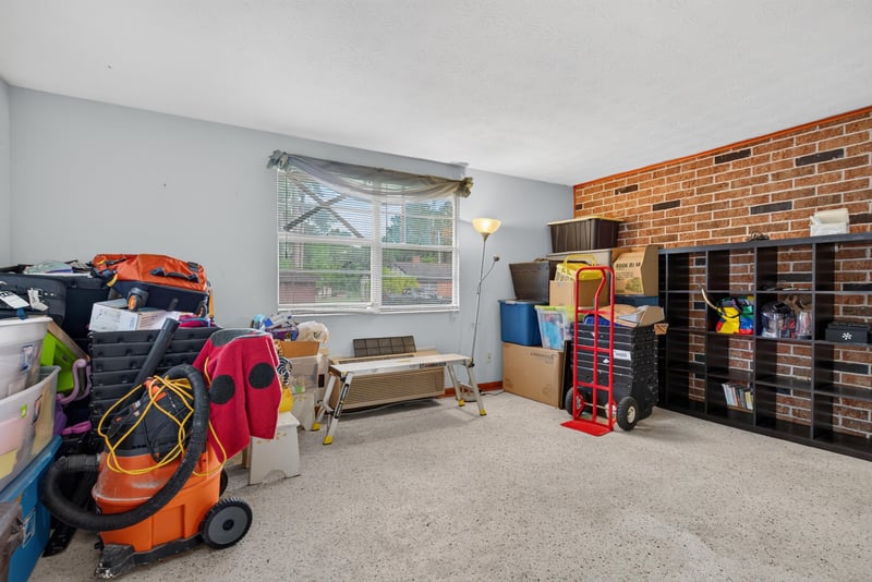Hallway with shelving and brick accent wall at 5745 110th St, Jacksonville, FL 32244