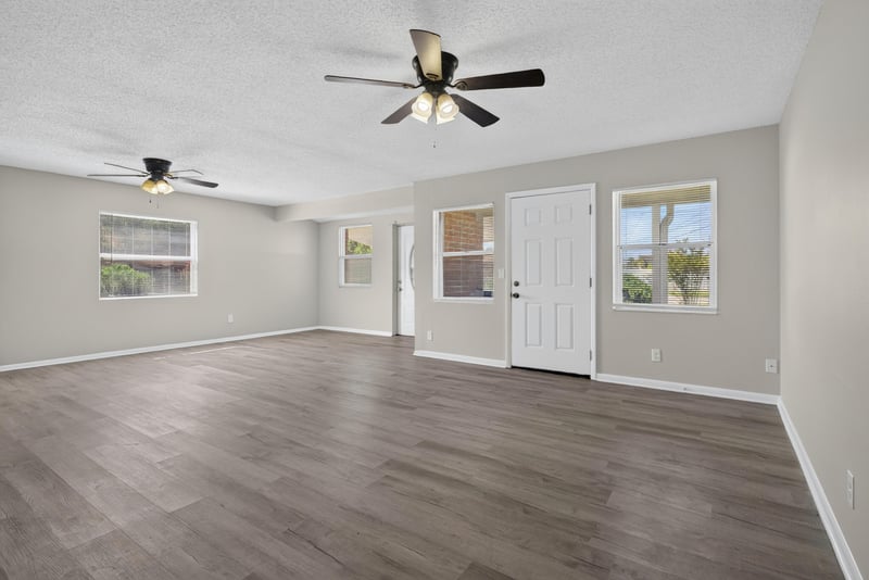 Living room with wood-look floor and ceiling fan at 5503 Boeing Dr, Jacksonville, FL 32207