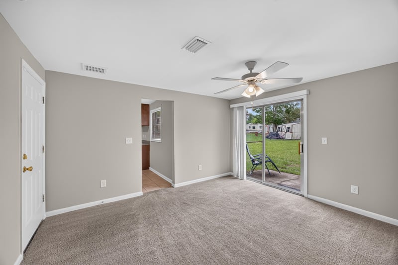 Room with sliding glass door to backyard at 1143 Tumbleweed Dr, Orange Park, FL 32065