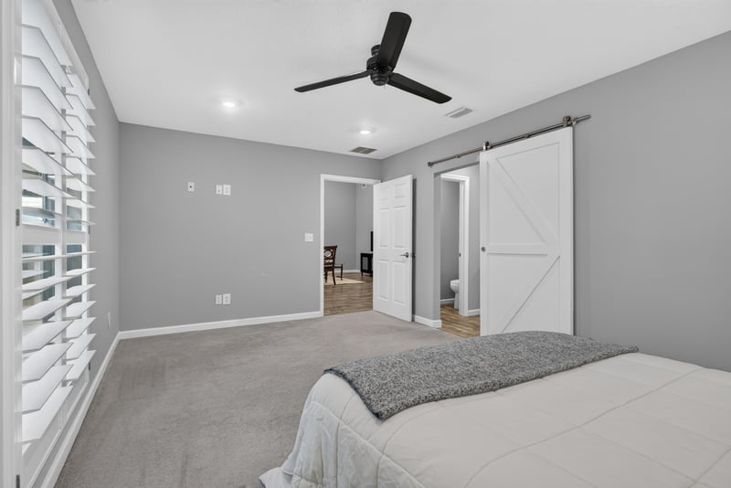 Bedroom with barn door accent, photographed by Megapixeler on Birch Run E, Orange Park