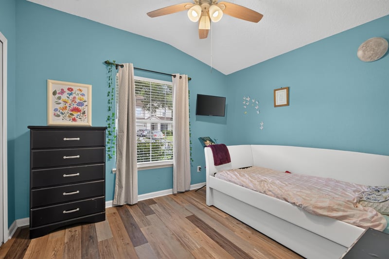 Bedroom with blue walls and ceiling fan at 2065 Creekmont Dr