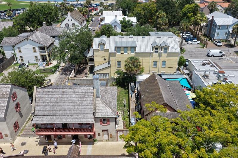 Aerial view of the property buildings and pool surrounded by trees at 29 Cuna St, St. Augustine, FL 32084