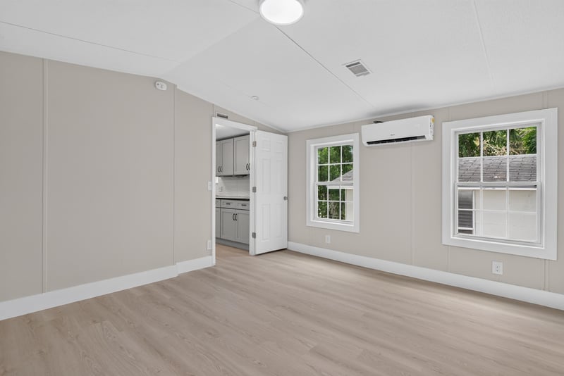 Primary bedroom with window and wood-look flooring at 4565 Appleton Ave, Jacksonville, FL