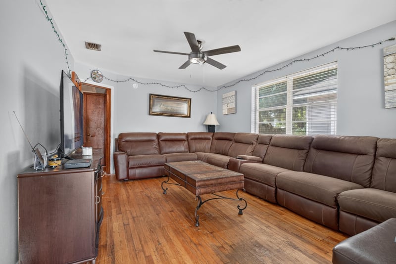 Living room with wood floors and ceiling fan at 450 E 46th St, Jacksonville, FL 32208