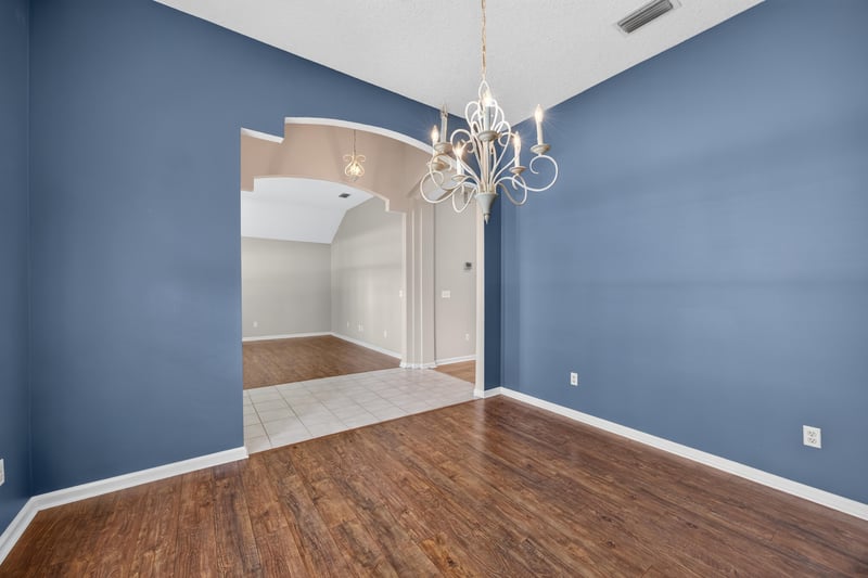Empty room with vaulted ceiling and blue walls at 1955 GUARDED Way, Fleming Island, FL 32003