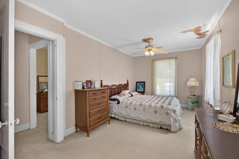 Bedroom with wood dresser and bed at 1173 US-17, Satsuma, FL 32189