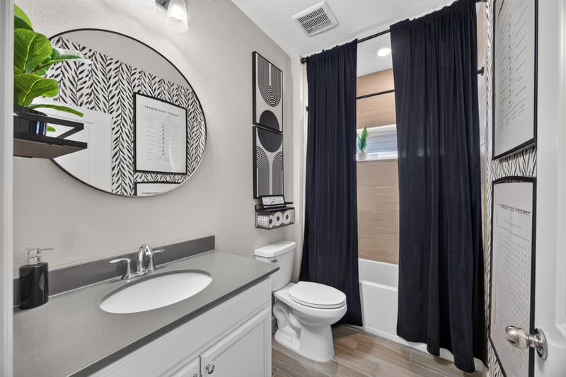 Secondary bathroom with vanity and dark curtain at 9942 Lovage Ln, Jacksonville, FL 32219