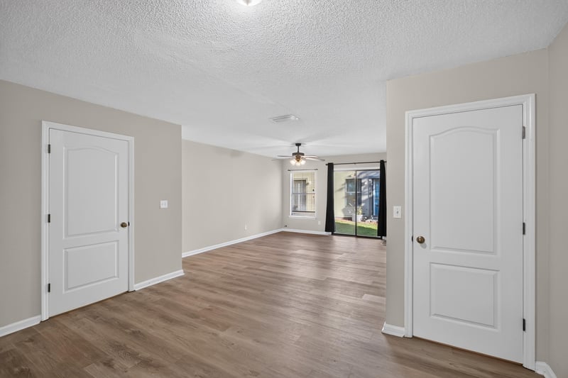 Living space with wood-look flooring and glass door at 7723 Playschool Ln, Jacksonville, FL