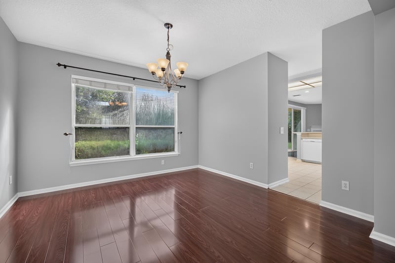 Dining area with chandelier and wood floors at 470 Sparrow Branch Cir, Jacksonville, FL 32259