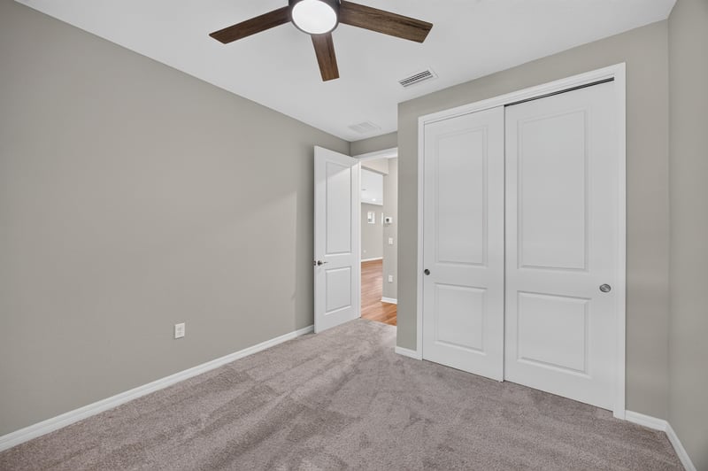 Bedroom with carpet, ceiling fan and closet doors at 171 Oyster Shell Ter, Nocatee, FL 32081