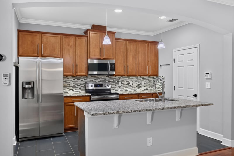 Kitchen with stainless refrigerator and wood cabinets at 6217 Eclipse Cir, Jacksonville, FL 32258