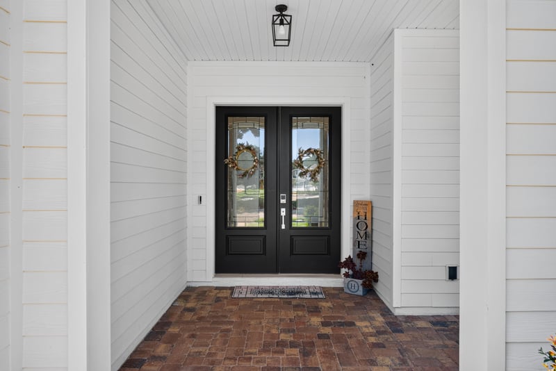 Front double entry doors and brick walkway at 22 Azura Point