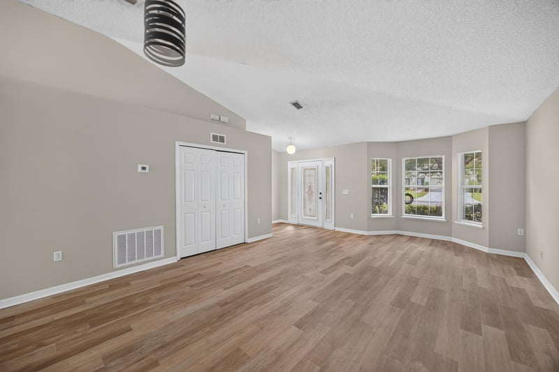 Living area with vaulted ceiling and window at 1845 Saga Ct, Middleburg, FL